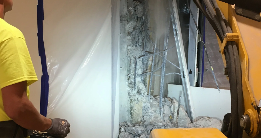 Compact demolition robot breaking reinforced concrete slab (1)